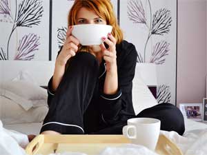 Woman Easting Breakfast  in Bed - She Could Have Used a Kitchen Cart!